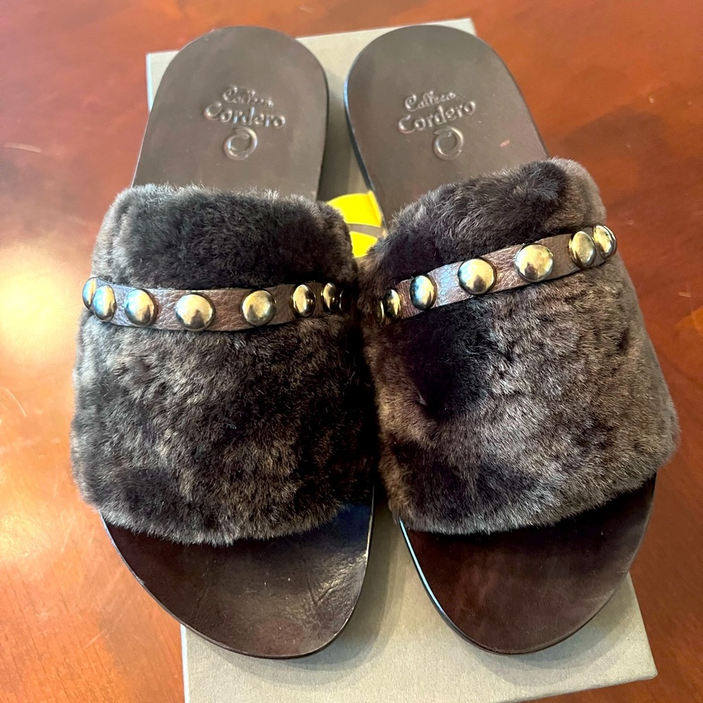 Leather slippers never worn. Beautiful design and rich color.